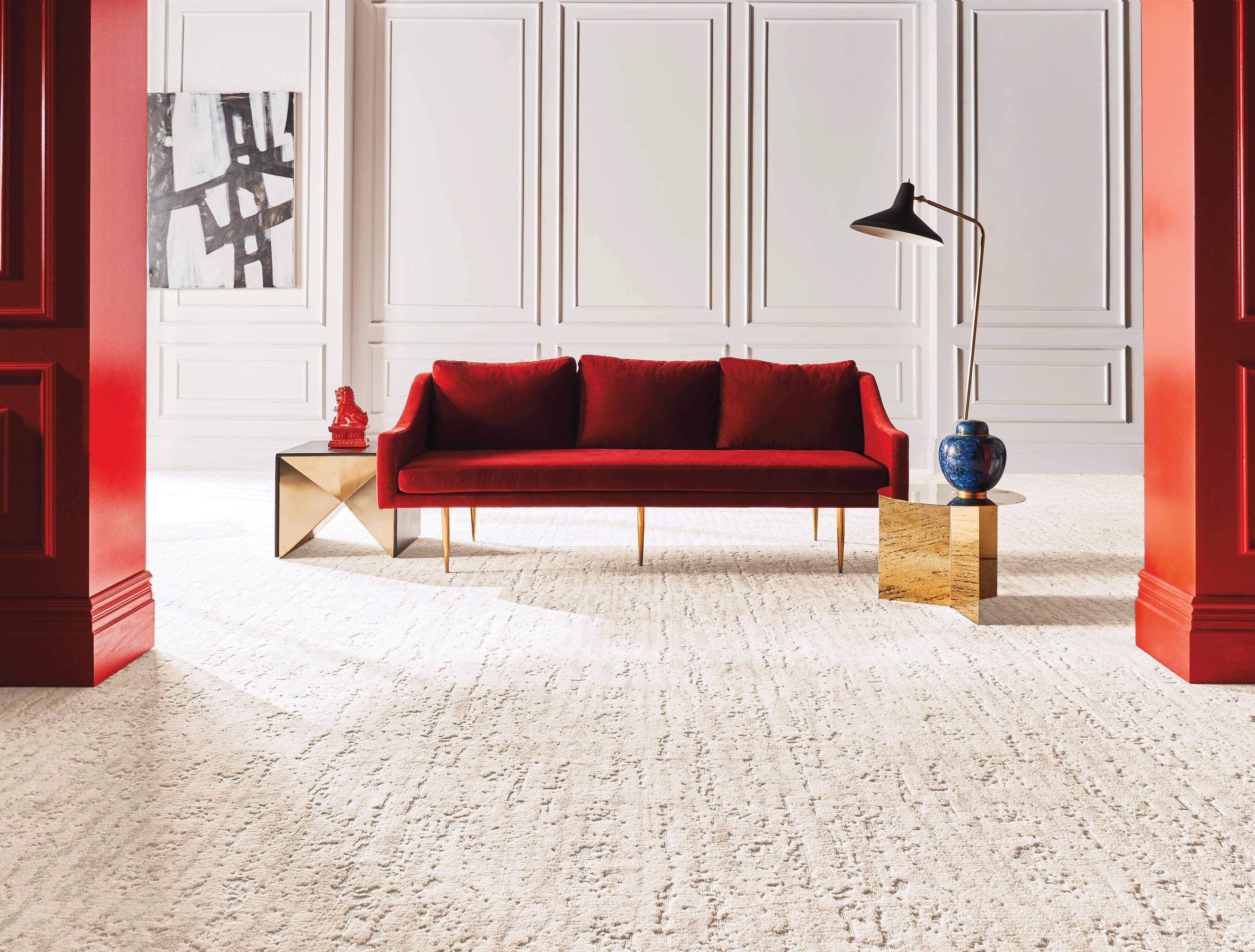 bright living room with a red velvet couch and beige textured carpet from B & B Floor Co in Springfield, VA