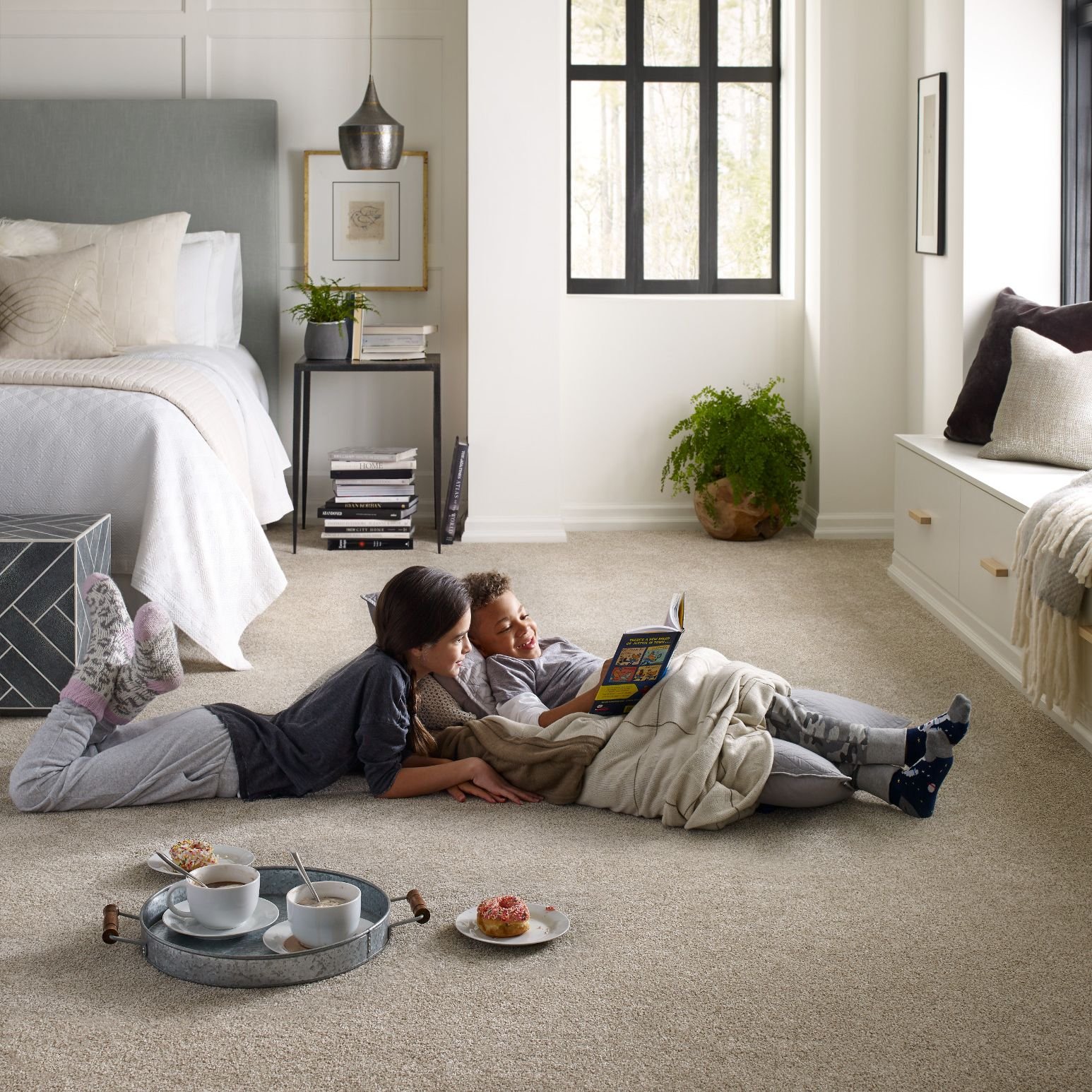 Two kids reading on bedroom carpet from B & B Floor Co in Springfield, VA